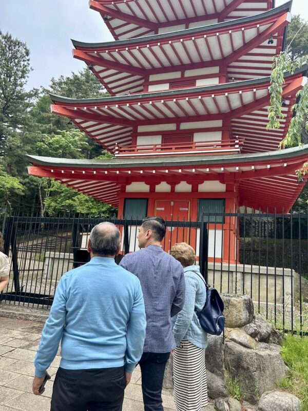 Our tour guide helping tourists appreciate a pagoda